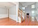 Spacious living room featuring hardwood floors, staircase, fireplace, and soaring ceilings at 3554 Cherry Blossom Court, Loganville, GA 30052