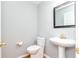 Small bathroom with pedestal sink, toilet, and framed mirror at 3554 Cherry Blossom Ct, Loganville, GA 30052