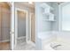Bathroom features a soaking tub, tiled surround and storage shelves at 3554 Cherry Blossom Ct, Loganville, GA 30052