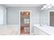 Bright bathroom featuring a soaking tub and double sink vanity at 3554 Cherry Blossom Ct, Loganville, GA 30052