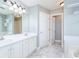 Bright bathroom boasts double sinks, white cabinets and ample storage space at 3554 Cherry Blossom Ct, Loganville, GA 30052