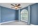 Bedroom showcasing large arch window, ceiling fan, and neutral colored walls at 3554 Cherry Blossom Ct, Loganville, GA 30052