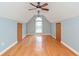 Spacious bonus room with hardwood floors, a ceiling fan and natural light at 3554 Cherry Blossom Ct, Loganville, GA 30052