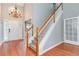 Light and airy entryway with a chandelier, white front door, and staircase with carpeted treads at 3554 Cherry Blossom Ct, Loganville, GA 30052