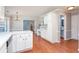 Bright kitchen features hardwood floors, white cabinets, and a breakfast bar at 3554 Cherry Blossom Ct, Loganville, GA 30052