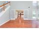 Bright living room featuring hardwood floors and an entry to the kitchen through glass paned doors at 3554 Cherry Blossom Ct, Loganville, GA 30052