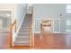 Open-concept living area showcasing stairs, hardwood floors, and a seamless flow to the kitchen at 3554 Cherry Blossom Ct, Loganville, GA 30052