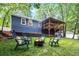 Inviting backyard with a fire pit, deck, and manicured lawn perfect for outdoor entertaining at 195 Ansley Ct, Roswell, GA 30076