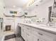 Bright bathroom featuring double sink vanity with marble countertop, shower with glass door, and wood floors at 195 Ansley Ct, Roswell, GA 30076