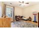 Stylish bedroom with twin bed, hardwood floors, and a window with curtains for natural light at 195 Ansley Ct, Roswell, GA 30076