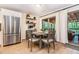 Cozy dining area adjacent to the kitchen with backyard views and stainless steel refrigerator at 195 Ansley Ct, Roswell, GA 30076