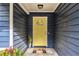 Inviting entrance with a bright yellow door and stylish 'hello' doormat at 195 Ansley Ct, Roswell, GA 30076