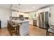 Modern kitchen featuring stainless steel appliances, a center island, and stylish bar stool seating at 195 Ansley Ct, Roswell, GA 30076