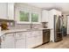 Bright kitchen featuring stainless steel appliances, a large window, and neutral countertops at 195 Ansley Ct, Roswell, GA 30076