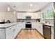 Well-appointed kitchen with stainless steel appliances and a large island with plenty of countertop space at 195 Ansley Ct, Roswell, GA 30076