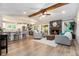 Open-concept living room with a stone fireplace, wood beam, and seamless flow to the kitchen at 195 Ansley Ct, Roswell, GA 30076