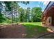 Sloping backyard featuring landscaped yard with lawn and mature trees offering a serene outdoor space at 2521 Wood Creek Ct, Dacula, GA 30019