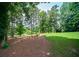 Beautiful backyard with mature trees and manicured lawn at 2521 Wood Creek Ct, Dacula, GA 30019