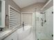 Bright bathroom featuring a soaking tub and walk-in shower with marble tiling and bronze fixtures at 2521 Wood Creek Ct, Dacula, GA 30019