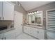 Bathroom including double sink vanity with granite counters, sleek fixtures, and ceramic tile flooring at 2521 Wood Creek Ct, Dacula, GA 30019