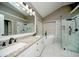 This bathroom boasts double sinks, granite countertops, a soaking tub and glass enclosed shower at 2521 Wood Creek Ct, Dacula, GA 30019