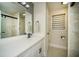 Modern bathroom featuring a stylish vanity, decorative mirror, and a glass-enclosed shower at 2521 Wood Creek Ct, Dacula, GA 30019