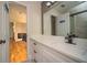 Well-lit bathroom with a sleek countertop and a view leading to the upstairs landing at 2521 Wood Creek Ct, Dacula, GA 30019