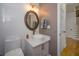 Chic half-bath featuring modern fixtures, a sleek vessel sink, a decorative mirror, and stylish white subway tile at 2521 Wood Creek Ct, Dacula, GA 30019