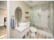 Modern bathroom with floating shelves, vessel sink vanity and sliding glass door shower at 2521 Wood Creek Ct, Dacula, GA 30019