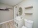 Charming bathroom featuring a vessel sink, floating shelves, and a modern toilet at 2521 Wood Creek Ct, Dacula, GA 30019