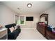 Comfortable bedroom with a dark sofa, large dresser, and neutral decor at 2521 Wood Creek Ct, Dacula, GA 30019