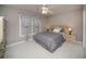 Serene bedroom featuring neutral tones, a comfortable bed, and ample natural light at 2521 Wood Creek Ct, Dacula, GA 30019