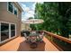 Outdoor deck featuring a dining set and umbrella, perfect for entertaining or relaxing in the fresh air at 2521 Wood Creek Ct, Dacula, GA 30019