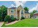 Charming two-story home with manicured lawn, columns at the entrance, and a welcoming, classic facade at 2521 Wood Creek Ct, Dacula, GA 30019