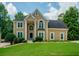 Charming two-story home with manicured lawn, columns at the entrance, and a welcoming, classic facade at 2521 Wood Creek Ct, Dacula, GA 30019