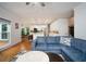 Bright and airy living room featuring hardwood floors, a comfortable sectional sofa, and access to an open concept kitchen at 2521 Wood Creek Ct, Dacula, GA 30019