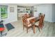 Open concept living room and dining area featuring wood-look floors and large windows at 2521 Wood Creek Ct, Dacula, GA 30019