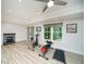Spacious living room with fireplace and workout equipment on modern wood-look floors at 2521 Wood Creek Ct, Dacula, GA 30019