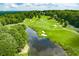 Overhead shot of a golf course featuring lush greens, sand traps, and serene water hazards at 2934 Mill Grove Ter, Dacula, GA 30019