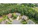 Aerial view of a neighborhood showcasing well-maintained homes with lush greenery and trees at 2934 Mill Grove Ter, Dacula, GA 30019