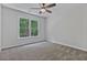Simple bedroom with neutral carpeting, ceiling fan and large window at 2934 Mill Grove Ter, Dacula, GA 30019