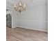 An open dining room with hardwood floors and an ornate chandelier at 2934 Mill Grove Ter, Dacula, GA 30019