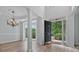 Open foyer with high ceilings, hardwood floors, a chandelier, and a view to the outside at 2934 Mill Grove Ter, Dacula, GA 30019