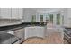 Modern kitchen featuring granite countertops, stainless appliances, and hardwood floors at 2934 Mill Grove Ter, Dacula, GA 30019