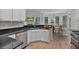 Modern kitchen with granite countertops, stainless steel appliances, and large windows for natural light at 2934 Mill Grove Ter, Dacula, GA 30019