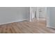 Open living room with hardwood floors and view into the kitchen and dining areas at 2934 Mill Grove Ter, Dacula, GA 30019