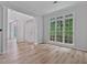 Spacious living room with hardwood floors, white trim, and large windows for natural light at 2934 Mill Grove Ter, Dacula, GA 30019