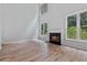 Open-concept living room with fireplace, large windows, and hardwood floors at 2934 Mill Grove Ter, Dacula, GA 30019