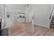 Open-concept living room with fireplace, hardwood floors, and staircase at 2934 Mill Grove Ter, Dacula, GA 30019