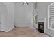 Bright living room features fireplace, hardwood floors, and tall windows at 2934 Mill Grove Ter, Dacula, GA 30019
